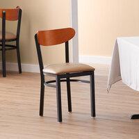 Lancaster Table & Seating Boomerang Black Finish Chair with 2 1/2 inch Light Brown Vinyl Padded Seat and Cherry Wood Back