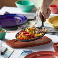 12 5/8 inch x 7 1/8 inch Oval Cast Iron Fajita Skillet with Gripper and Wood Underliner