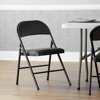 Lancaster Table & Seating Black Vinyl Folding Chair with Padded Seat