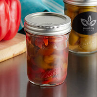 Ball 1440060801 8 oz. Half-Pint Regular Mouth Smooth Sided Glass Canning Jar with Silver Metal Lid and Band - 12/Case