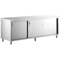 Regency 24 inch x 96 inch 16 Gauge Type 304 Stainless Steel Enclosed Base Table with Sliding Doors and Adjustable Midshelf