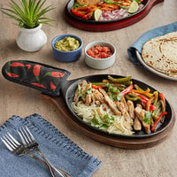 Choice 9 1/4 inch x 7 inch Oval Pre-Seasoned Cast Iron Fajita Skillet with Oak Finish Wood Underliner and Chili Pepper Cotton Handle Cover