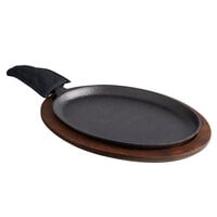 Valor 13 inch x 10 inch Oval Pre-Seasoned Cast Iron Fajita Skillet with Rustic Chestnut Finish Rubberwood Underliner and Black Cotton Handle Cover