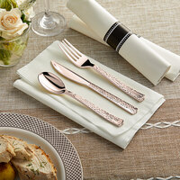 Visions 18 inch x 15 1/2 inch Pre-Rolled Linen-Feel White Napkin and Hammersmith Heavy Weight Rose Gold Plastic Cutlery Set - 100/Case