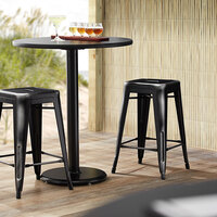 Lancaster Table & Seating Alloy Series Distressed Black Stackable Metal Indoor / Outdoor Industrial Cafe Counter Height Stool with Drain Hole Seat