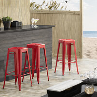 Lancaster Table & Seating Alloy Series Red Stackable Metal Indoor / Outdoor Industrial Barstool with Drain Hole Seat