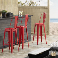 Lancaster Table & Seating Alloy Series Red Metal Indoor / Outdoor Industrial Cafe Barstool with Vertical Slat Back and Drain Hole Seat