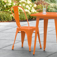 Lancaster Table & Seating Alloy Series Orange Metal Indoor / Outdoor Industrial Cafe Chair with Vertical Slat Back and Drain Hole Seat