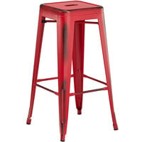 Lancaster Table & Seating Alloy Series Distressed Red Stackable Metal Indoor / Outdoor Industrial Barstool with Drain Hole Seat