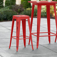 Lancaster Table & Seating Alloy Series Distressed Red Stackable Metal Indoor / Outdoor Industrial Barstool with Drain Hole Seat