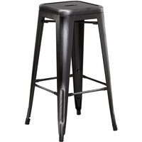 Lancaster Table & Seating Alloy Series Distressed Black Stackable Metal Indoor / Outdoor Industrial Barstool with Drain Hole Seat