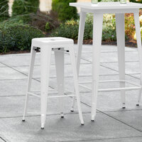 Lancaster Table & Seating Alloy Series White Stackable Metal Indoor / Outdoor Industrial Barstool with Drain Hole Seat