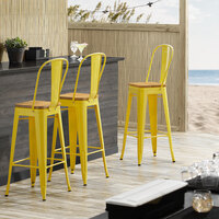 Lancaster Table & Seating Alloy Series Yellow Metal Indoor Industrial Cafe Bar Height Stool with Vertical Slat Back and Natural Wood Seat