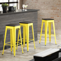 Lancaster Table & Seating Alloy Series Yellow Metal Indoor Industrial Cafe Bar Height Stool with Black Wood Seat