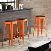 Lancaster Table & Seating Alloy Series Orange Metal Indoor Industrial Cafe Bar Height Stool with Walnut Wood Seat