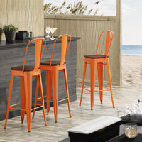 Lancaster Table & Seating Alloy Series Orange Metal Indoor Industrial Cafe Bar Height Stool with Vertical Slat Back and Walnut Wood Seat