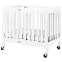 Foundations 2131120 Boutique 24 inch x 38 inch Matte White Compact Slatted Wood Folding Crib with Oversized Casters and 3 inch InfaPure Mattress