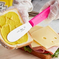 Choice 3 1/2 inch Smooth Stainless Steel Sandwich Spreader with Neon Pink Polypropylene Handle