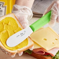 Choice 3 1/2 inch Smooth Stainless Steel Sandwich Spreader with Neon Green Polypropylene Handle