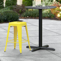Lancaster Table & Seating Alloy Series Yellow Stackable Metal Outdoor Industrial Cafe Counter Height Stool with Drain Hole Seat