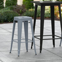 Lancaster Table & Seating Alloy Series Charcoal Stackable Metal Indoor / Outdoor Industrial Barstool with Drain Hole Seat