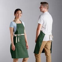 Choice Hunter Green Poly-Cotton Adjustable Bib Apron with 2 Pockets and Natural Webbing Accents - 32" x 30"