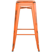 Lancaster Table & Seating Alloy Series Distressed Orange Stackable Metal Indoor / Outdoor Industrial Barstool with Drain Hole Seat