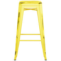 Lancaster Table & Seating Alloy Series Distressed Yellow Stackable Metal Indoor / Outdoor Industrial Barstool with Drain Hole Seat