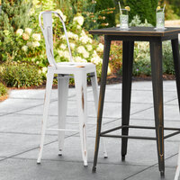Lancaster Table & Seating Alloy Series Distressed White Metal Indoor / Outdoor Industrial Cafe Barstool with Vertical Slat Back and Drain Hole Seat