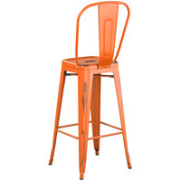 Lancaster Table & Seating Alloy Series Distressed Orange Metal Indoor / Outdoor Industrial Cafe Barstool with Vertical Slat Back and Drain Hole Seat