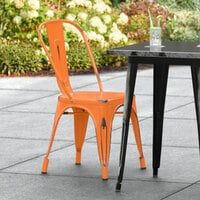 Lancaster Table & Seating Alloy Series Distressed Orange Metal Indoor / Outdoor Industrial Cafe Chair with Vertical Slat Back and Drain Hole Seat