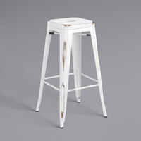 Lancaster Table & Seating Alloy Series Distressed White Stackable Metal Indoor / Outdoor Industrial Barstool with Drain Hole Seat