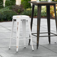Lancaster Table & Seating Alloy Series Distressed White Stackable Metal Indoor / Outdoor Industrial Barstool with Drain Hole Seat