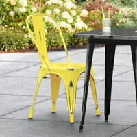 Lancaster Table & Seating Alloy Series Distressed Yellow Metal Indoor / Outdoor Industrial Cafe Chair with Vertical Slat Back and Drain Hole Seat