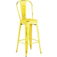 Lancaster Table & Seating Alloy Series Distressed Yellow Metal Indoor / Outdoor Industrial Cafe Barstool with Vertical Slat Back and Drain Hole Seat