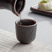Acopa Heika 1.5 oz. Black Matte Textured Stoneware Sake Cup - 24/Case