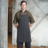 Uncommon Threads 3018 Black and White Chalk Stripe Customizable Poly-Cotton Butcher Bib Apron with 2 Pockets - 34 inchL x 23 inchW