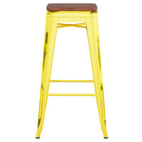 Lancaster Table & Seating Alloy Series Distressed Yellow Stackable Metal Indoor Industrial Barstool with Walnut Wood Seat