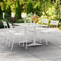 Lancaster Table & Seating 32 inch x 48 inch White Powder-Coated Aluminum Dining Height Outdoor Table with Umbrella Hole and 4 Side Chairs