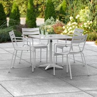 Lancaster Table & Seating 32 inch x 32 inch Silver Powder-Coated Aluminum Dining Height Outdoor Table with Umbrella Hole and 4 Arm Chairs