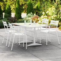 Lancaster Table & Seating 32 inch x 60 inch White Powder-Coated Aluminum Dining Height Outdoor Table with Umbrella Hole and 4 Arm Chairs