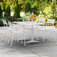 Lancaster Table & Seating 32 inch x 48 inch White Powder-Coated Aluminum Dining Height Outdoor Table with Umbrella Hole and 4 Arm Chairs