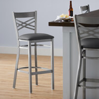 Lancaster Table & Seating Clear Coat Finish Cross Back Bar Stool with 2 1/2 inch Dark Gray Vinyl Padded Seat - Detached