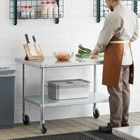 Regency 30 inch x 48 inch 18-Gauge 304 Stainless Steel Commercial Work Table with Galvanized Legs, Undershelf, and Casters
