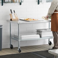 Regency 30 inch x 60 inch 18-Gauge 304 Stainless Steel Commercial Work Table with Galvanized Legs, Undershelf, and Casters
