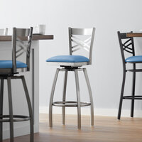 Lancaster Table & Seating Clear Coat Finish Cross Back Swivel Bar Stool with 2 1/2 inch Blue Vinyl Padded Seat