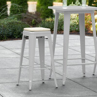 Lancaster Table & Seating Alloy Series Silver Stackable Metal Indoor / Outdoor Industrial Barstool with Tan Fabric Magnetic Cushion