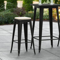 Lancaster Table & Seating Alloy Series Black Stackable Metal Indoor / Outdoor Industrial Barstool with Tan Fabric Magnetic Cushion
