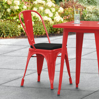 Lancaster Table & Seating Alloy Series Red Stackable Metal Indoor / Outdoor Industrial Cafe Chair with Vertical Slat Back and Black Fabric Magnetic Cushion