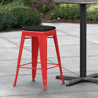 Lancaster Table & Seating Alloy Series Red Stackable Metal Indoor / Outdoor Industrial Cafe Counter Height Stool with Black Fabric Magnetic Cushion